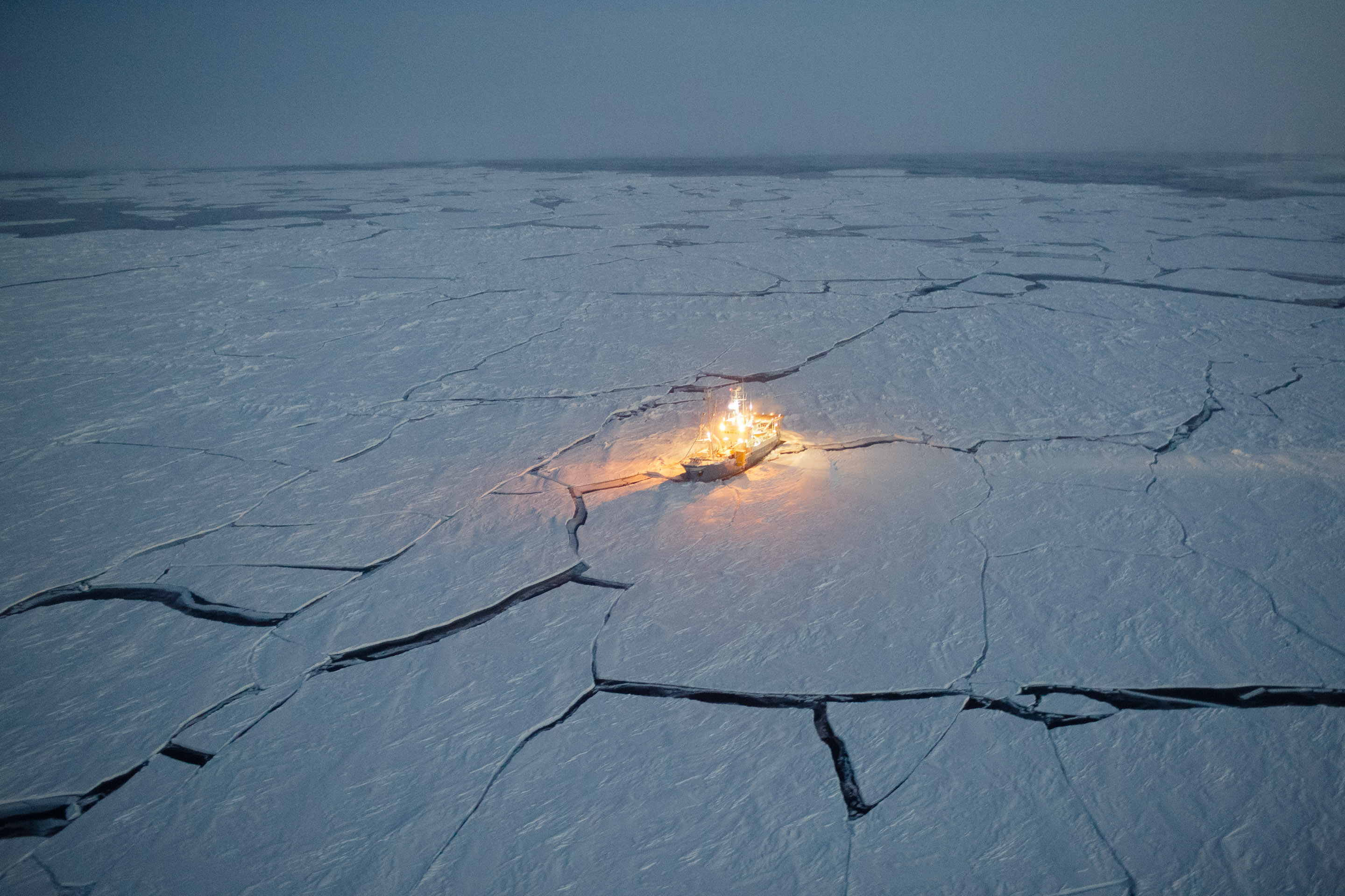 Leads in the Arctic sea ice can be seen separating ice floes from one-another in this photo shot from a helicopter as it was approaching the Lance. (Source: Nick Cobbing/Norwegian Polar Institute)