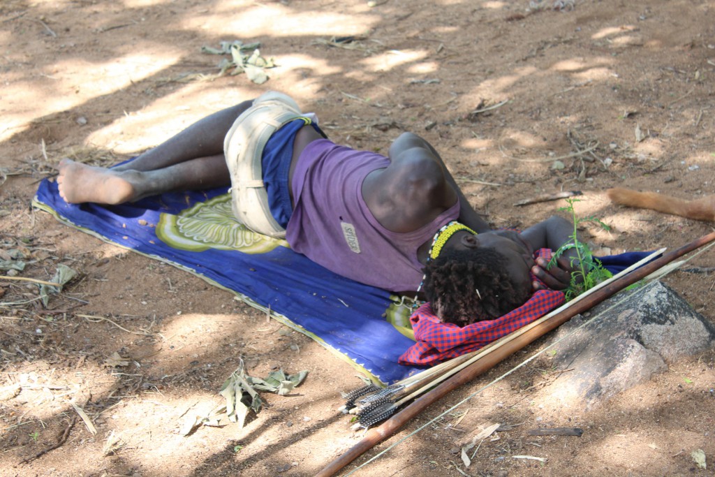 You snooze, you lose? Au contraire...A Hadza man napping now will likely be awake when other members of his community are fast asleep, maintaining a varied range of chronotypes that was once essential for survival. (Credit David Samson)