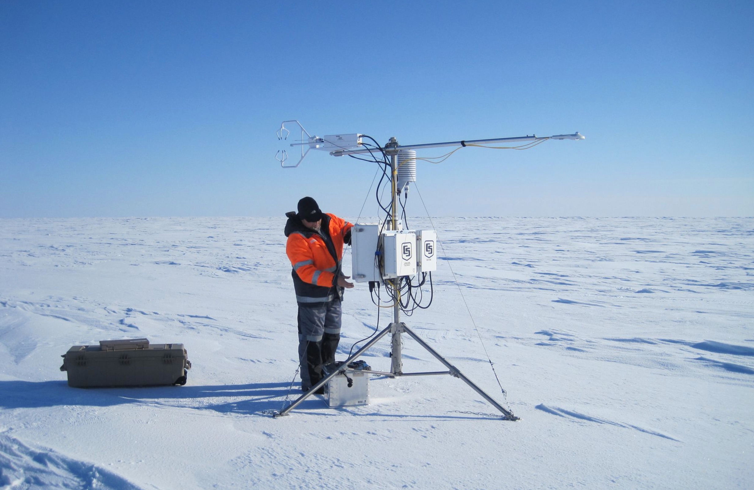 A member of the Norwegian N-ICE2015 expedition adjusts an instrument out on an Arctic Ocean ice floe that measures wind and temperature. (Source: Mats Granskog/Stephen Hudson, Norwegian Polar Institute)