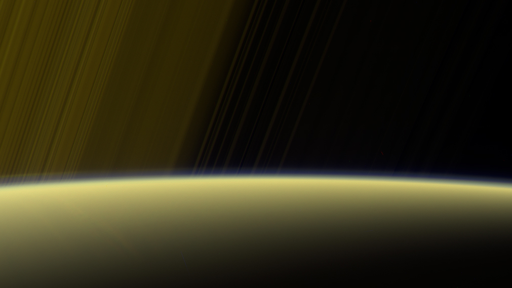 false-color view from NASA's Cassini spacecraft gazes toward the rings beyond Saturn's sunlit horizon, where a thin haze can be seen along the limb. (Source: NASA/JPL-Caltech/Space Science Institute)