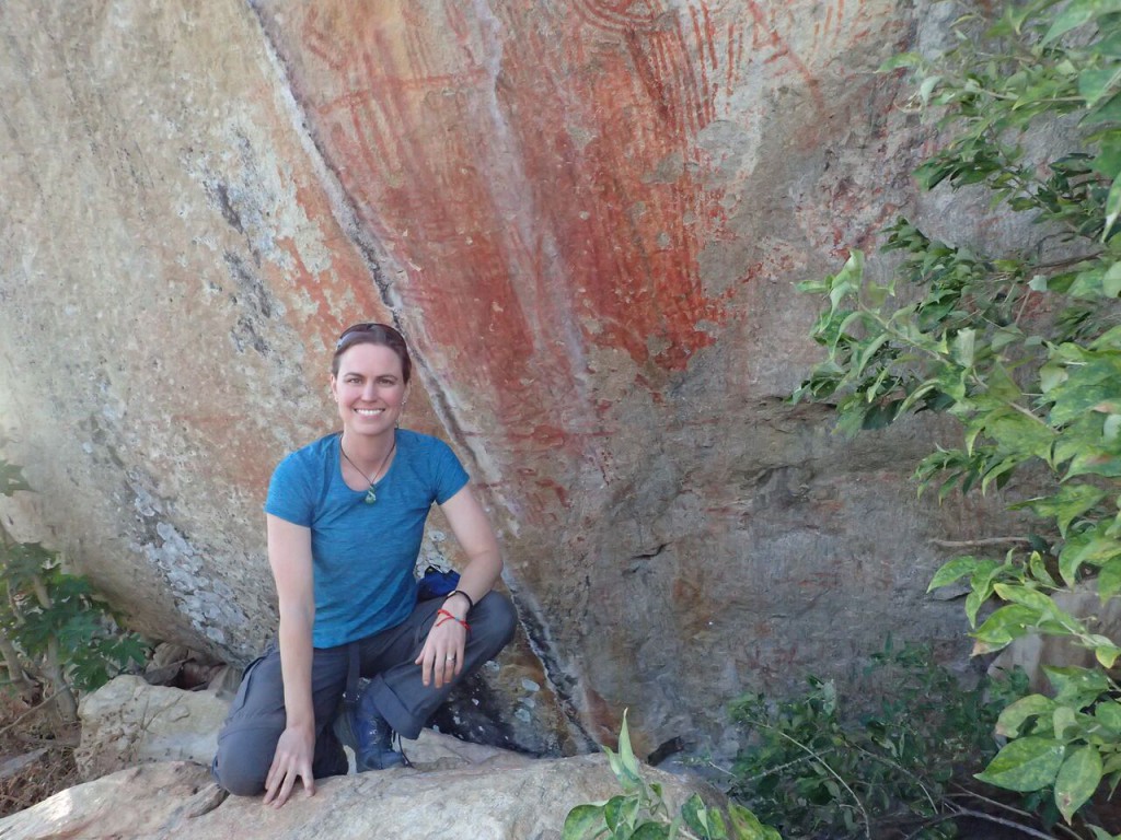 Emory University anthropologist Jessica Thompson with rock art from a site call Mwanambavi in Malawi. She explains: “The rock art was almost certainly created by hunter-gatherers, but we don’t know how long ago. In this part of Malawi it is always these kinds of abstract designs. We don’t know what they mean as there are no living people who can tell us, but this particular site is different from other rock art sites in the area. It is by far the most well-preserved, and the motifs show over-painting that suggests many generations of coming to this same place. It sits at the confluence of a few streams and is a very prominent landmark. My interpretation is that it was used as a territorial marker or a place where many different groups congregated in the past. That would explain the diversity and abundance of art at the site.” Photo by Suzanne Kunitz, Emory University.