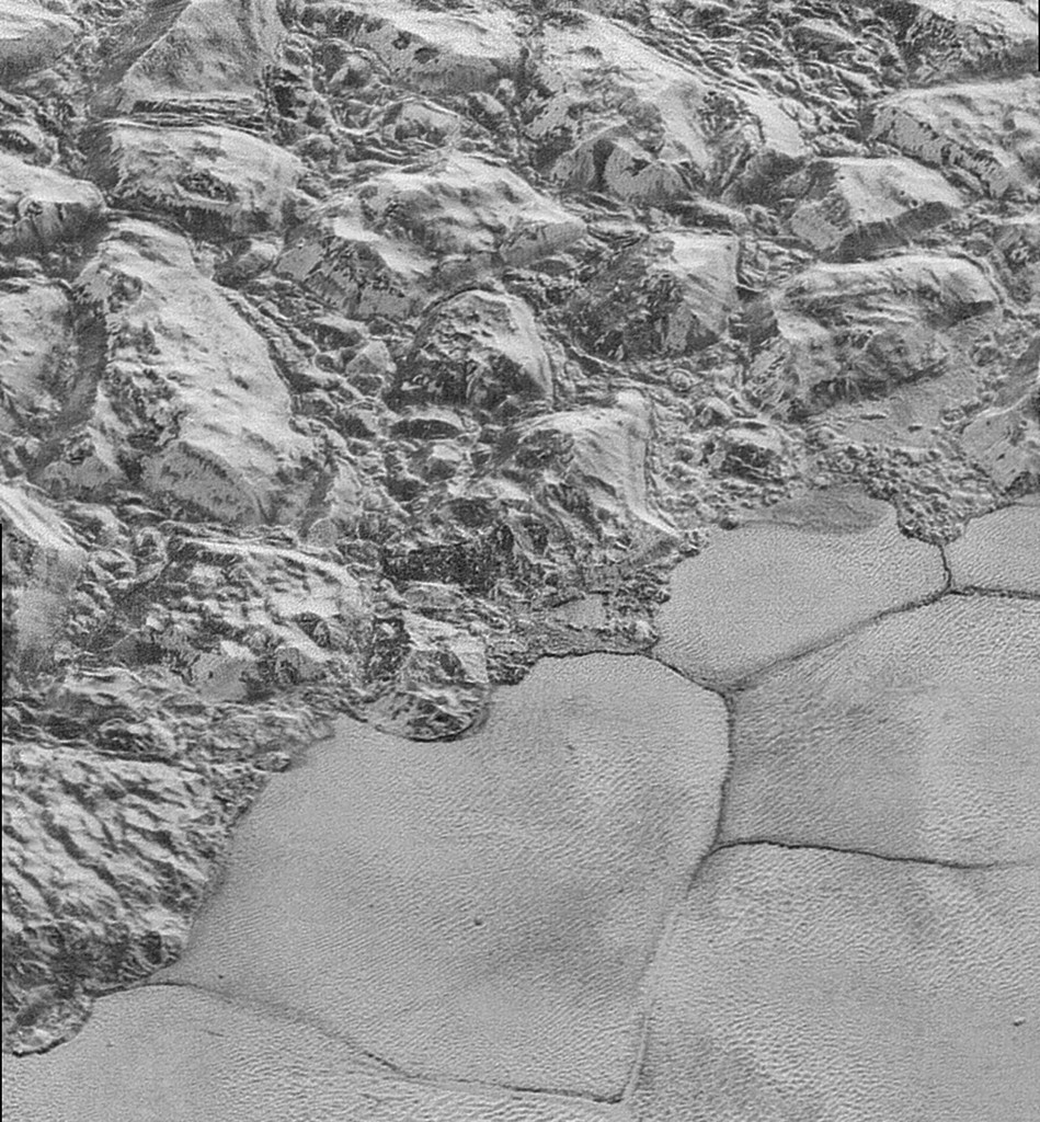 The edges of icy plains where they meet mountains on Pluto, seen by New Horizons. NASA