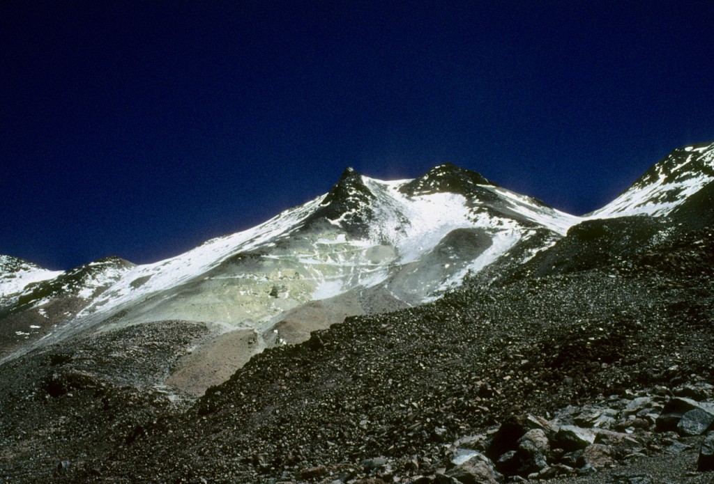 A view towards the summit of Aucanquilcha. You can see the sulfur (yellow) along with the old mining road zig-zagging across the slope. Erik Klemetti