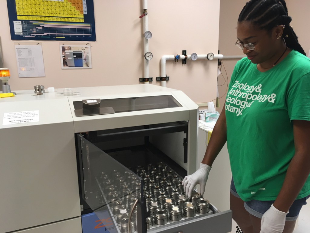 My research student loading samples into an XRF during her summer project. Erik Klemetti