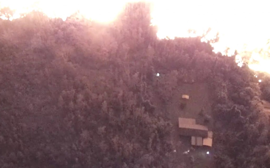 Drone footage used to help find a resident from the Kīlauea lava flows. The glow at the top are lava flows and the beams from searchers flashlights can be seen near the house. USGS/HVO.