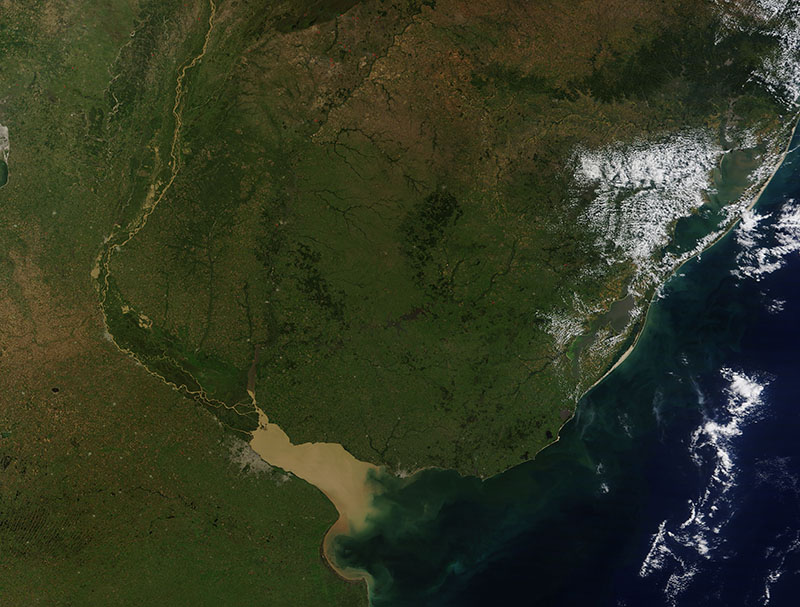 The tan/brown line in the middle of the image is the Rio de la Plata and its muddy waters are entering the Pacific Ocean. To the north of the river is Uruguay. NASA.